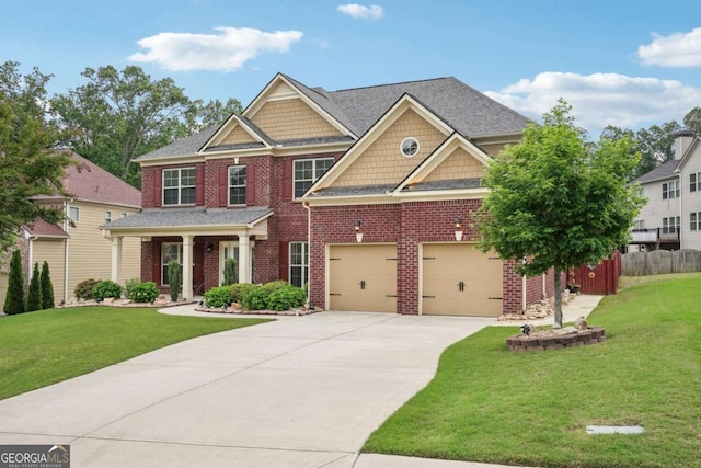 craftsman inspired home with an attached garage, fence, a front lawn, brick siding, and driveway