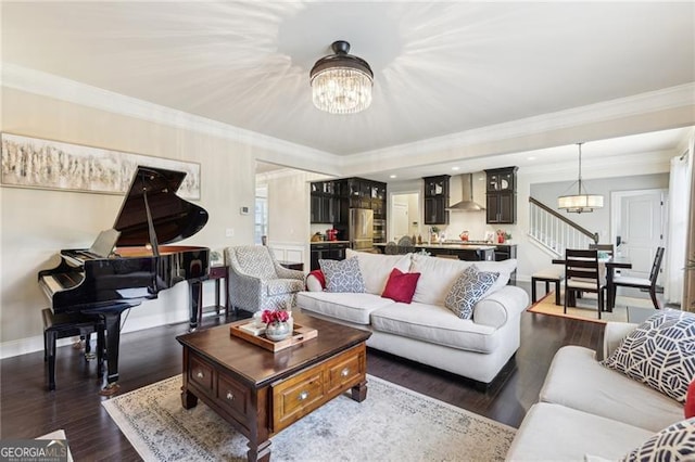 living area with baseboards, a chandelier, crown molding, dark wood-type flooring, and stairway