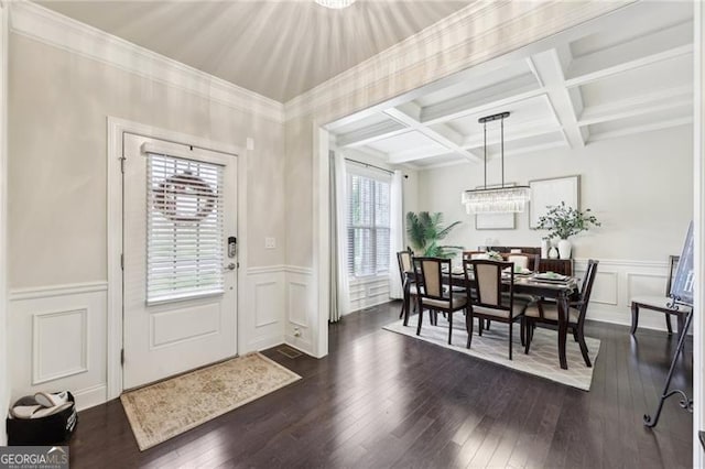entrance foyer with a wealth of natural light, a decorative wall, and a wainscoted wall