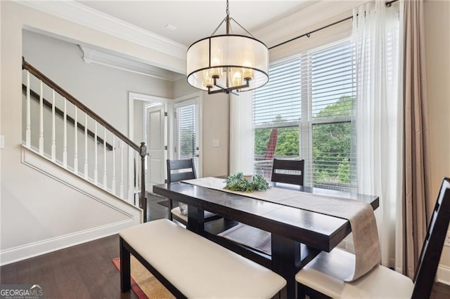 dining space with a notable chandelier, dark wood finished floors, stairway, baseboards, and ornamental molding