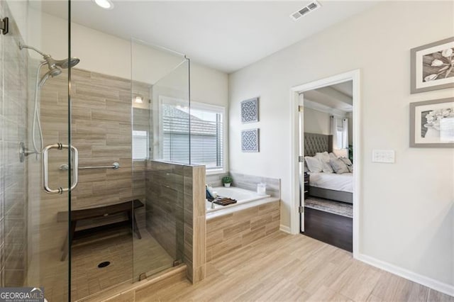bathroom featuring a stall shower, ensuite bathroom, visible vents, a bath, and wood finished floors