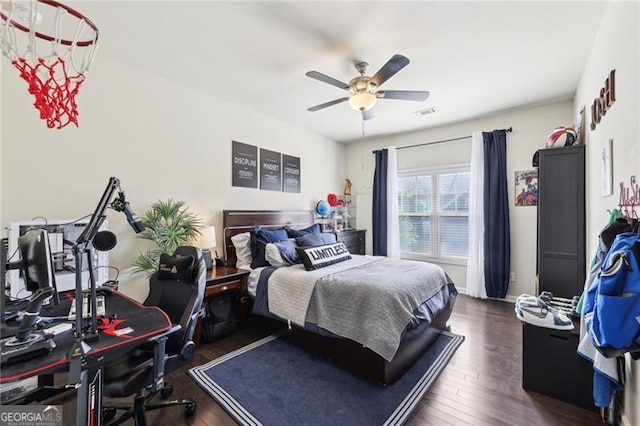 bedroom with a ceiling fan, visible vents, and wood finished floors