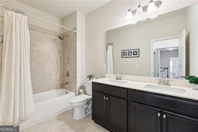 full bathroom featuring a sink, double vanity, toilet, and shower / bath combo with shower curtain