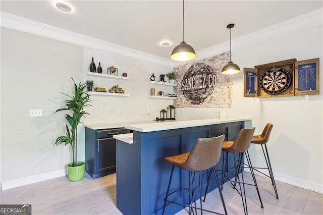bar with baseboards, ornamental molding, and light wood finished floors