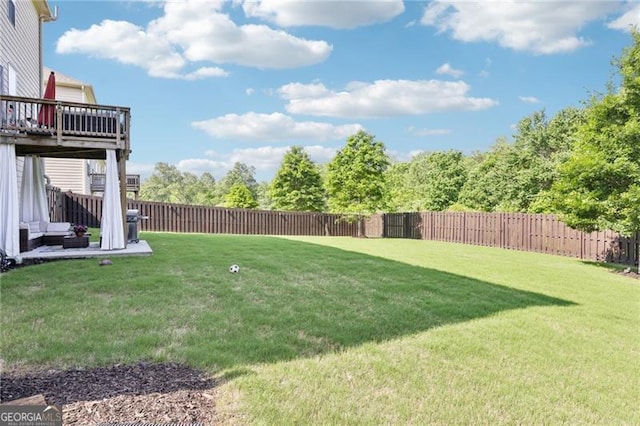 view of yard with a fenced backyard and a wooden deck