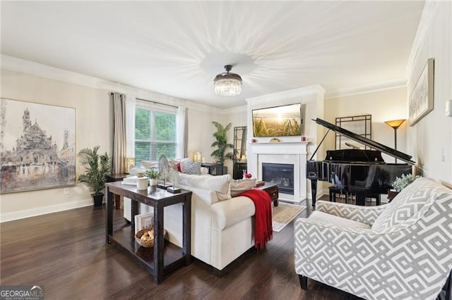 living area with crown molding, dark wood finished floors, baseboards, and a glass covered fireplace