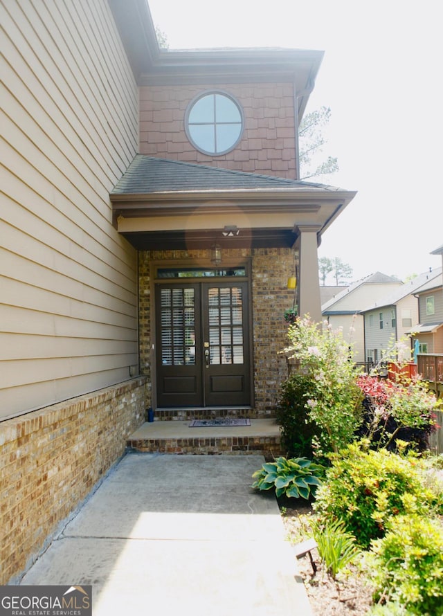 doorway to property with brick siding and french doors