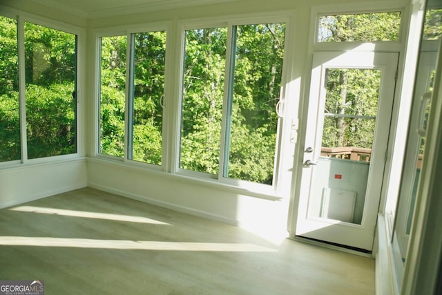 unfurnished sunroom with baseboards