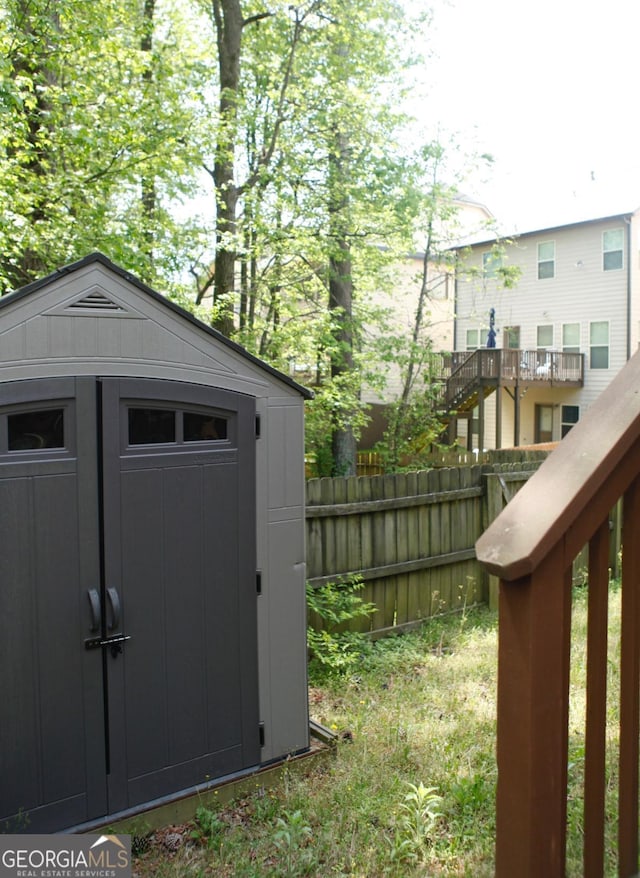 view of shed featuring fence