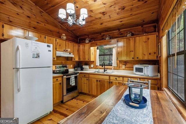 kitchen featuring a sink, white appliances, vaulted ceiling, under cabinet range hood, and light wood-style flooring