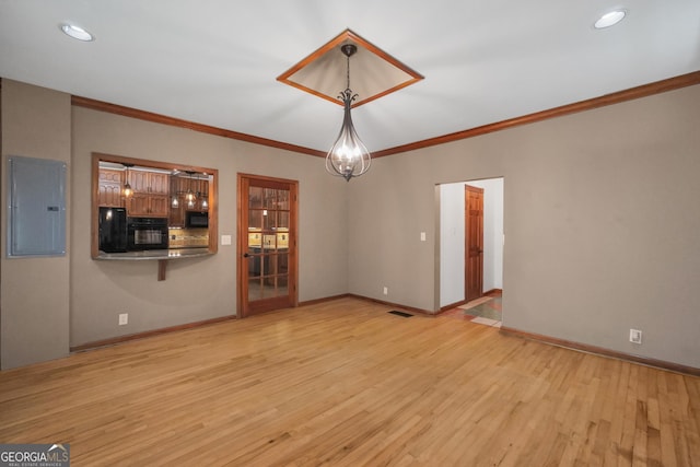 341 Fox Rd, Griffin, GA 30224 - unfurnished living room featuring electric panel, ornamental molding, light wood finished floors, and baseboards