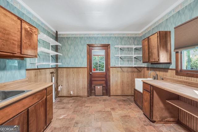 341 Fox Rd, Griffin, GA 30224 - kitchen featuring open shelves, light stone finish floors, a wainscoted wall, brown cabinetry, and wallpapered walls