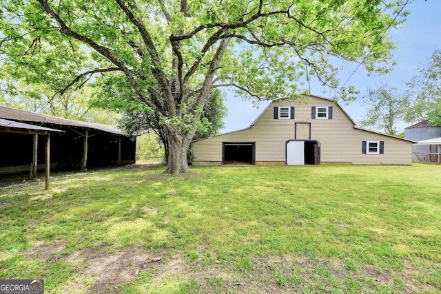 341 Fox Rd, Griffin, GA 30224 - view of grassy yard with a detached garage, an outdoor structure, a barn, and a pole building