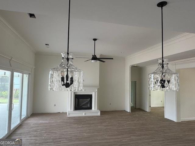 2191 Isles Of St Marys Way, Saint Marys, GA 31558 - unfurnished living room featuring a glass covered fireplace, crown molding, and ceiling fan with notable chandelier