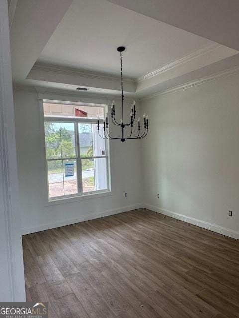 2191 Isles Of St Marys Way, Saint Marys, GA 31558 - unfurnished dining area with crown molding, a raised ceiling, and dark wood-style floors