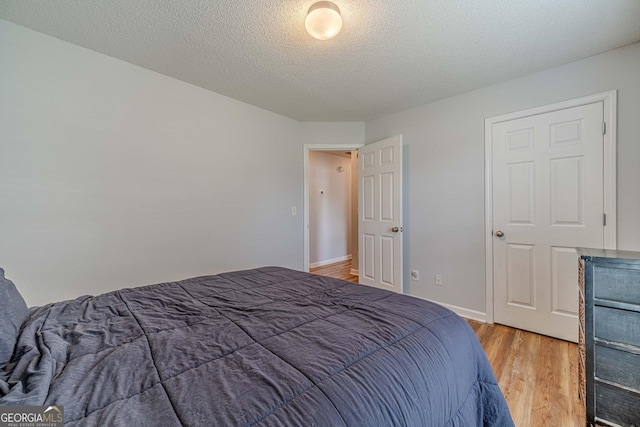 463 Rebekah Dr, Bethlehem, GA 30620 - bedroom with light wood-type flooring, baseboards, and a textured ceiling