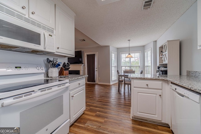 463 Rebekah Dr, Bethlehem, GA 30620 - kitchen with a textured ceiling, white appliances, white cabinets, and wood finished floors