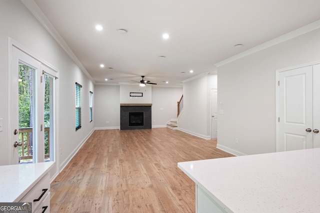 63 Brookstone Park E, Acworth, GA 30101 - unfurnished living room with ornamental molding, recessed lighting, light wood-style flooring, a ceiling fan, and a fireplace