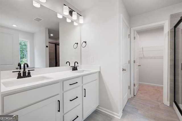 63 Brookstone Park E, Acworth, GA 30101 - full bath with a shower stall, a spacious closet, double vanity, baseboards, and recessed lighting