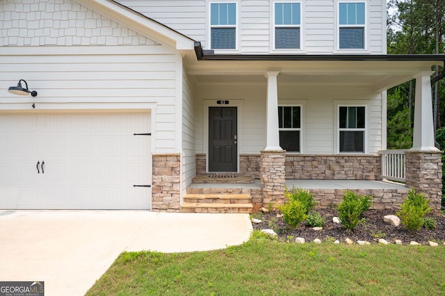 63 Brookstone Park E, Acworth, GA 30101 - doorway to property with a porch, stone siding, a garage, and concrete driveway
