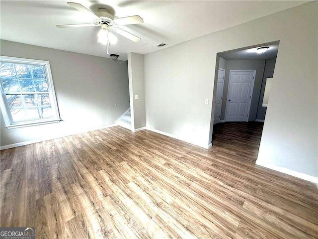 6945 Autumn Hills Dr, Cumming, GA 30028 - empty room with visible vents, wood finished floors, baseboards, and ceiling fan