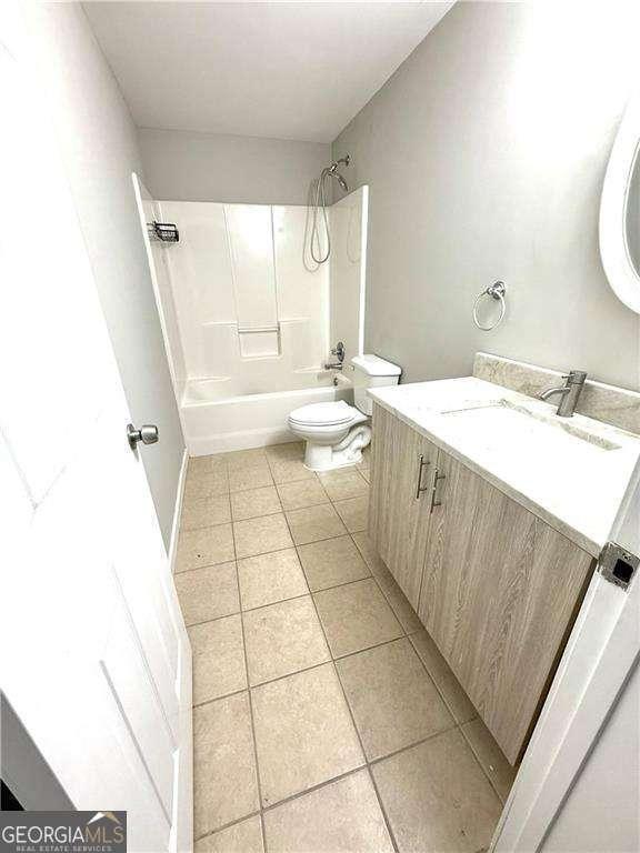 6945 Autumn Hills Dr, Cumming, GA 30028 - bathroom featuring toilet, tile patterned floors, vanity, and shower / tub combination