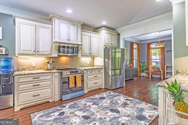 1122 Irongate, Macon, GA 31220 - kitchen with light stone countertops, ornamental molding, an inviting chandelier, dark wood-type flooring, and appliances with stainless steel finishes
