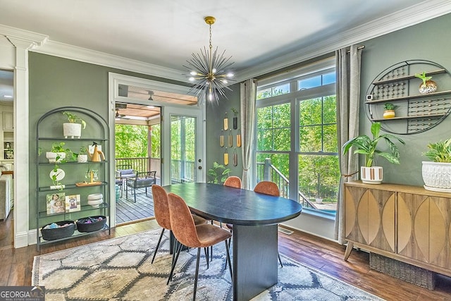 1122 Irongate, Macon, GA 31220 - dining space featuring ornamental molding, a healthy amount of sunlight, a chandelier, and wood-type flooring