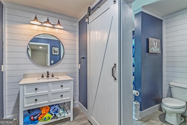 1122 Irongate, Macon, GA 31220 - bathroom featuring baseboards, wood walls, toilet, and wood finished floors