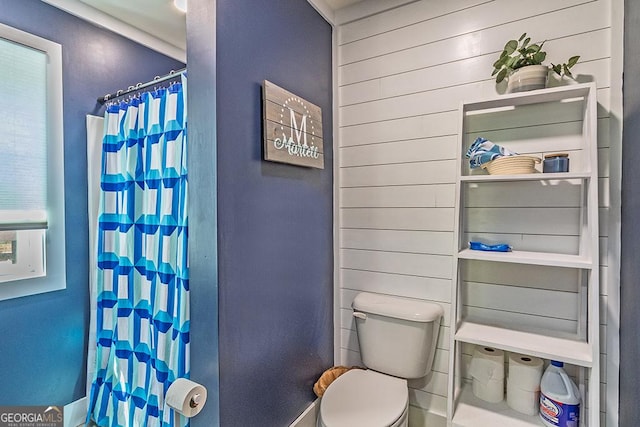 1122 Irongate, Macon, GA 31220 - full bath with toilet, baseboards, wood walls, and curtained shower