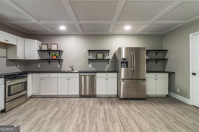 1122 Irongate, Macon, GA 31220 - kitchen with light wood-style flooring, a sink, open shelves, dark countertops, and appliances with stainless steel finishes