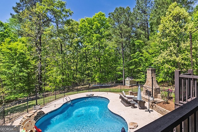 1122 Irongate, Macon, GA 31220 - view of swimming pool featuring a wooded view, a patio area, fence, and a fenced in pool