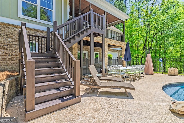 1122 Irongate, Macon, GA 31220 - view of patio featuring outdoor dining space, fence, a wooden deck, a fenced in pool, and stairs