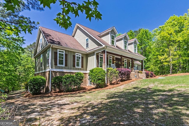 1122 Irongate, Macon, GA 31220 - view of side of home featuring a lawn, board and batten siding, brick siding, a shingled roof, and a porch