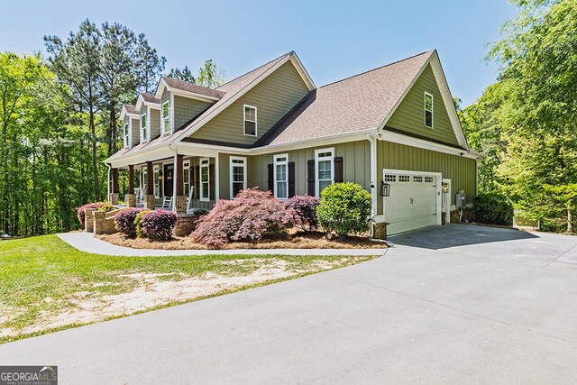 1122 Irongate, Macon, GA 31220 - view of front facade featuring covered porch, concrete driveway, a garage, board and batten siding, and a shingled roof