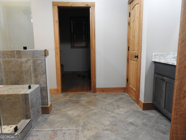full bathroom with baseboards and vanity