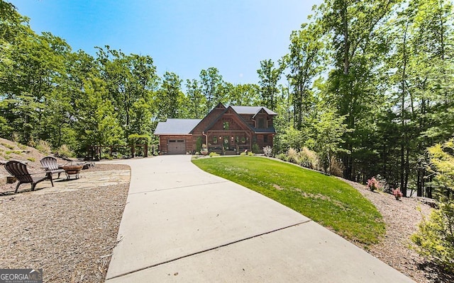 366 Shepherds Way, Morganton, GA 30560 - cabin featuring an outdoor fire pit, a front lawn, driveway, and a garage