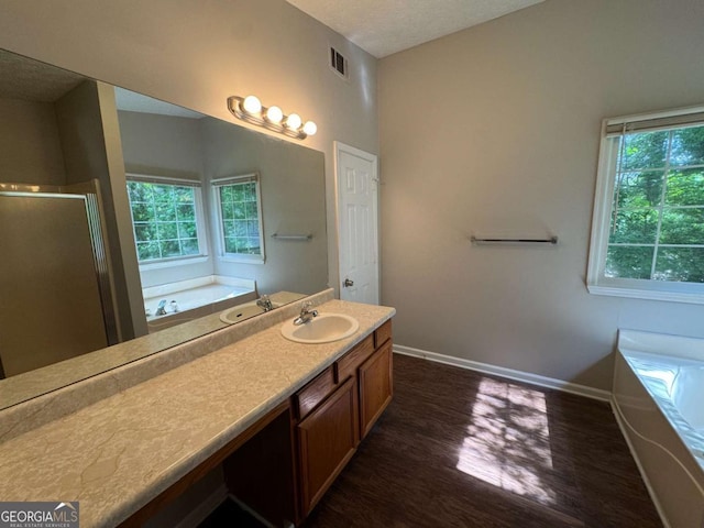 1048 Brandon Ln, Stone Mountain, GA 30083 - full bathroom featuring a garden tub, baseboards, visible vents, and wood finished floors