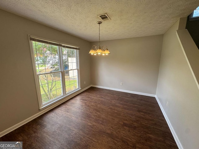 1048 Brandon Ln, Stone Mountain, GA 30083 - unfurnished dining area with a textured ceiling, visible vents, dark wood-style floors, a notable chandelier, and baseboards