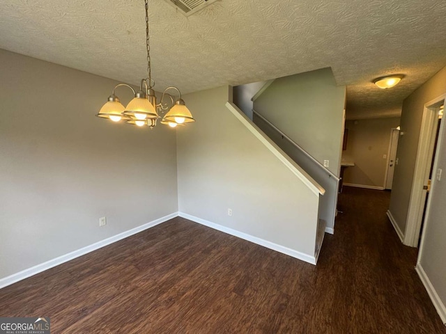1048 Brandon Ln, Stone Mountain, GA 30083 - interior space with wood finished floors, a textured ceiling, visible vents, baseboards, and a chandelier