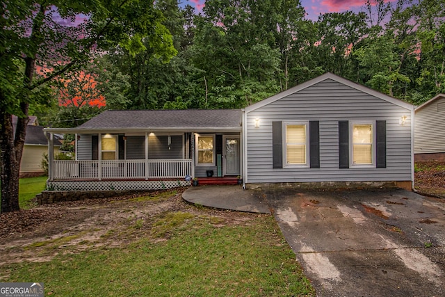 7845 Chase Woods Dr, Jonesboro, GA 30236 - view of front of property featuring a porch, a yard, and concrete driveway