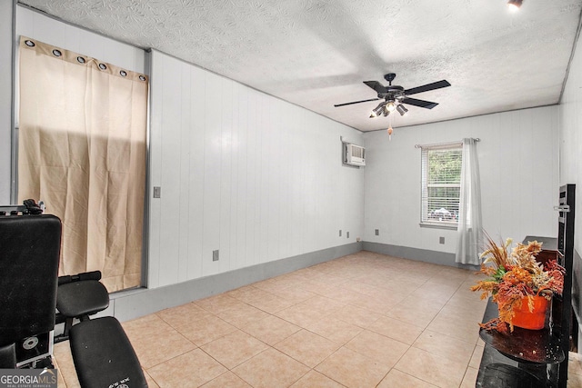 7845 Chase Woods Dr, Jonesboro, GA 30236 - living room featuring a ceiling fan, a wall mounted AC, a textured ceiling, and tile patterned floors