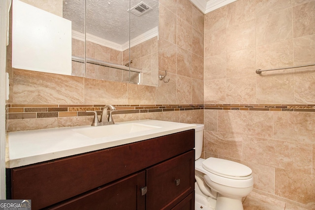 7845 Chase Woods Dr, Jonesboro, GA 30236 - bathroom featuring ornamental molding, vanity, toilet, tile walls, and a textured ceiling