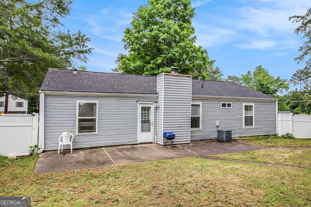 7845 Chase Woods Dr, Jonesboro, GA 30236 - rear view of property featuring a patio area, central AC unit, a chimney, and a shingled roof