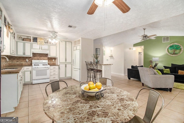 7845 Chase Woods Dr, Jonesboro, GA 30236 - dining space featuring ceiling fan, light tile patterned floors, a textured ceiling, and lofted ceiling