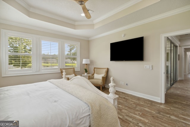 106 Jake Colton Dr, Kingsland, GA 31548 - bedroom with baseboards, wood finished floors, a raised ceiling, and ornamental molding