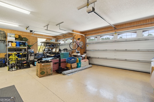 106 Jake Colton Dr, Kingsland, GA 31548 - garage featuring wood walls and a garage door opener