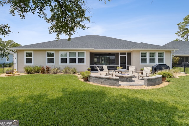 106 Jake Colton Dr, Kingsland, GA 31548 - back of property with an outdoor fire pit, stucco siding, fence, and a yard