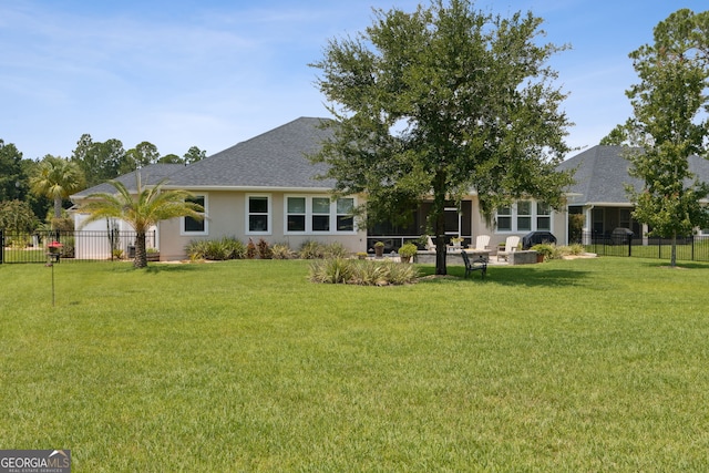 106 Jake Colton Dr, Kingsland, GA 31548 - rear view of house with a yard, fence, and stucco siding