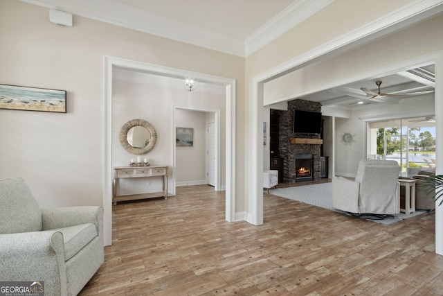 106 Jake Colton Dr, Kingsland, GA 31548 - living room with beam ceiling, light wood-type flooring, a fireplace, crown molding, and a ceiling fan